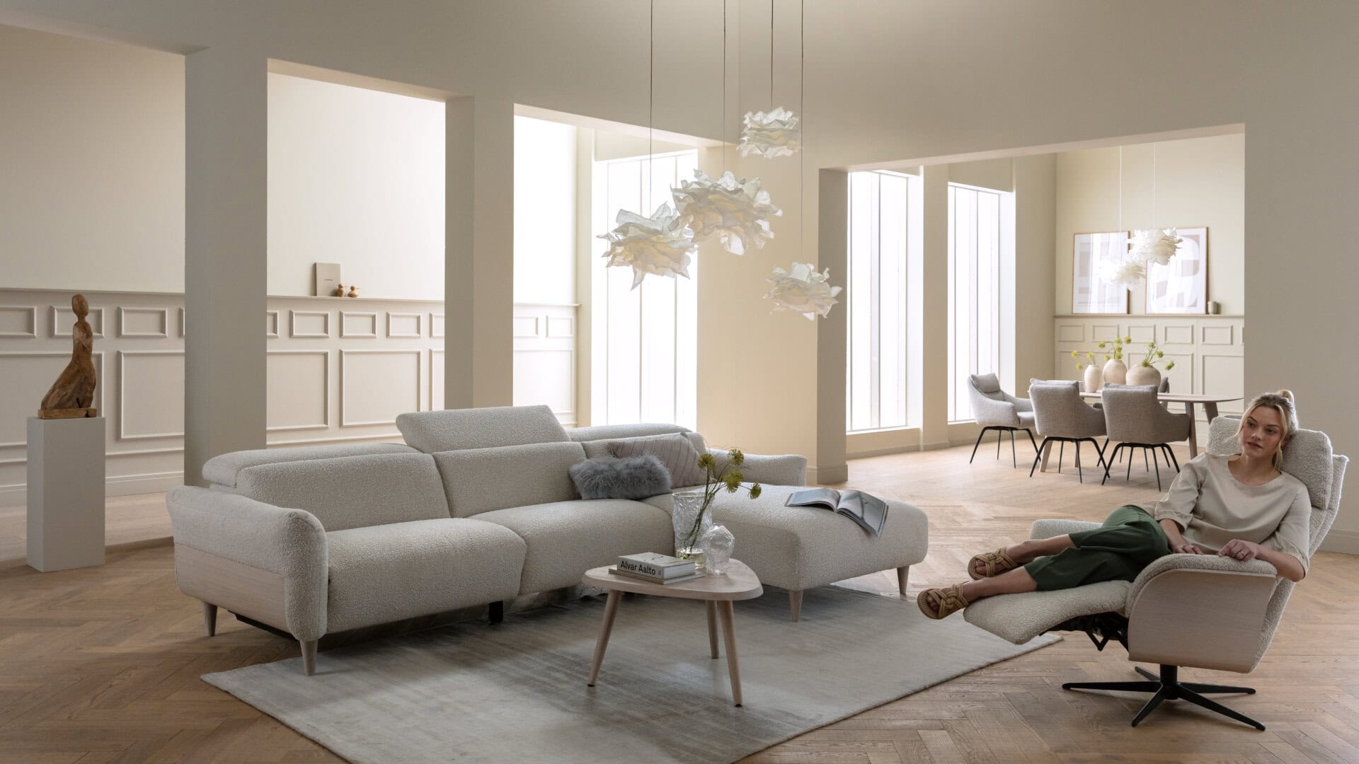 Skagen Studio Birkholm modular sofa in cream fabric, in a bright living room with two people on the sofa.