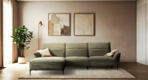 Skagen Studio Funen sofa in olive fabric, in a warm-toned living room with framed prints on the wall.